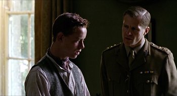 Movie still from “The Wind that Shakes the Barley” (2006), directed by Ken Loach – A man and a woman standing next to each other in a room; Close Up shot, Over the shoulder angle