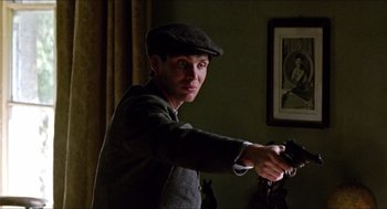 Movie still from “The Wind that Shakes the Barley” (2006), directed by Ken Loach – A man holding a video game controller in his hand; Close Up shot, Low angle