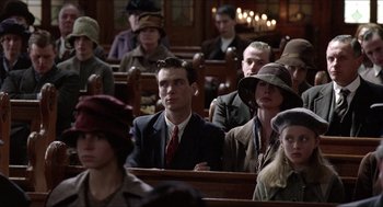 Movie still from “The Wind that Shakes the Barley” (2006), directed by Ken Loach – A group of people sitting in a room; Medium shot, High angle