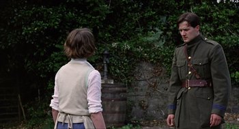 Movie still from “The Wind that Shakes the Barley” (2006), directed by Ken Loach – Two people standing in front of a tree; Medium shot, Over the shoulder angle