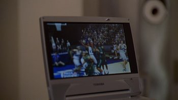 Movie still from “The Wire” (2002), created by David Simon – A television screen showing a basketball game; Extreme Close Up shot, High angle