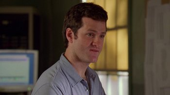 Movie still from “The Wire” (2002), created by David Simon – A person wearing a blue shirt; Close Up shot, Over the shoulder angle