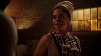 Movie still from “Snowfall” (2017), directed by Hiro Murai – A woman wearing a head scarf and a dress; Close Up shot, Low angle