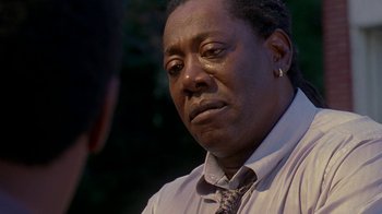 Movie still from “The Wire” (2002), created by David Simon – An older man in a shirt and tie looking at a younger man; Close Up shot, Low angle