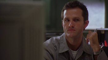 Movie still from “The Wire” (2002), created by David Simon – A person sitting in front of a window; Close Up shot, Low angle
