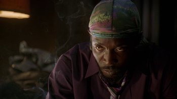 Movie still from “The Wire” (2002), created by David Simon – A person wearing a hat; Close Up shot, Low angle