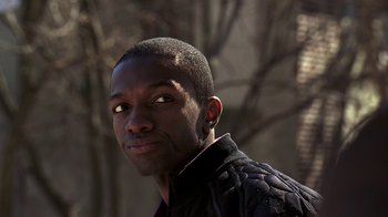 Movie still from “The Wire” (2002), created by David Simon – A person wearing a jacket; Close Up shot, Low angle