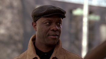 Movie still from “The Wire” (2002), created by David Simon – A person wearing a hat; Close Up shot, Low angle