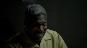 Movie still from “The Wire” (2002), created by David Simon – A person with his mouth open; Close Up shot, High angle