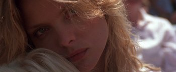 Movie still from “The Witches of Eastwick” (1987), directed by George Miller – A woman's face with long blonde hair; Extreme Close Up shot, Low angle