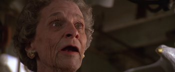 Movie still from “The Witches of Eastwick” (1987), directed by George Miller – An old woman with a sad look on her face; Close Up shot, Low angle