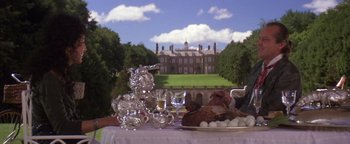 Movie still from “The Witches of Eastwick” (1987), directed by George Miller – A table set up for an outdoor dinner party; Medium shot, Low angle