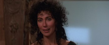 Movie still from “The Witches of Eastwick” (1987), directed by George Miller – A person wearing a black shirt; Close Up shot, Over the shoulder angle