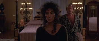 Movie still from “The Witches of Eastwick” (1987), directed by George Miller – A person wearing a black shirt; Close Up shot, Over the shoulder angle