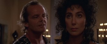 Movie still from “The Witches of Eastwick” (1987), directed by George Miller – A man and a woman looking at each other in a room; Close Up shot, Over the shoulder angle