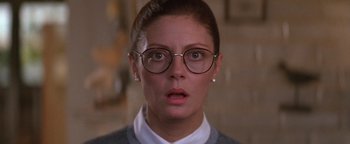 Movie still from “The Witches of Eastwick” (1987), directed by George Miller – A person wearing glasses and a sweater; Close Up shot, Low angle