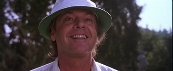 Movie still from “The Witches of Eastwick” (1987), directed by George Miller – A person wearing a hat; Close Up shot, Low angle