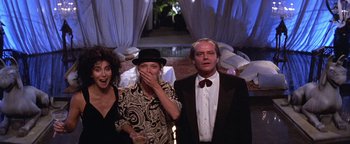Movie still from “The Witches of Eastwick” (1987), directed by George Miller – Two women and a man standing in front of a white curtain; Medium shot, Low angle