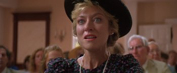 Movie still from “The Witches of Eastwick” (1987), directed by George Miller – A person wearing a hat; Close Up shot, Low angle