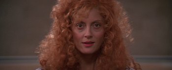 Movie still from “The Witches of Eastwick” (1987), directed by George Miller – A person with long red hair; Close Up shot, Low angle