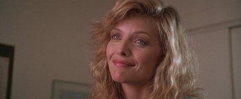 Movie still from “The Witches of Eastwick” (1987), directed by George Miller – A person with long blonde hair; Close Up shot, Low angle