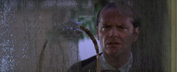 Movie still from “The Witches of Eastwick” (1987), directed by George Miller – A person holding a wooden stick; Close Up shot, Low angle