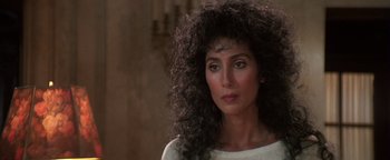 Movie still from “The Witches of Eastwick” (1987), directed by George Miller – A person wearing a white shirt; Close Up shot, High angle