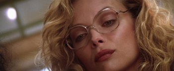 Movie still from “The Witches of Eastwick” (1987), directed by George Miller – A person wearing glasses; Extreme Close Up shot, Low angle