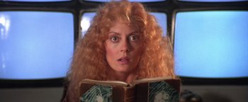 Movie still from “The Witches of Eastwick” (1987), directed by George Miller – A person reading a book; Close Up shot, Low angle