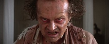 Movie still from “The Witches of Eastwick” (1987), directed by George Miller – A man's face as he stares at the camera; Close Up shot, Low angle