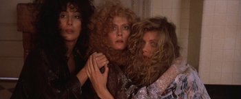 Movie still from “The Witches of Eastwick” (1987), directed by George Miller – A group of women standing next to each other in a room; Close Up shot, Low angle