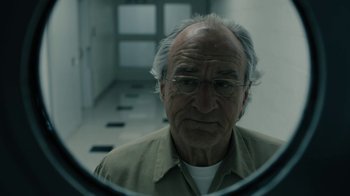 Movie still from “The Wizard of Lies” (2017), directed by Barry Levinson – An older man looking into a mirror in a room; Close Up shot, Low angle