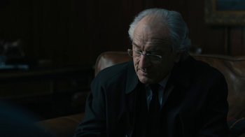 Movie still from “The Wizard of Lies” (2017), directed by Barry Levinson – An old man wearing glasses and a suit; Close Up shot, Over the shoulder angle