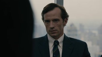 Movie still from “The Wizard of Lies” (2017), directed by Barry Levinson – A person wearing a suit and tie; Close Up shot, Over the shoulder angle
