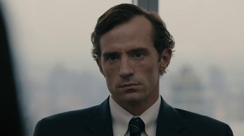 Movie still from “The Wizard of Lies” (2017), directed by Barry Levinson – A person wearing a suit and tie; Close Up shot, Low angle