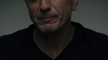 Movie still from “The Wizard of Lies” (2017), directed by Barry Levinson – A man's face in a black shirt; Extreme Close Up shot, Low angle