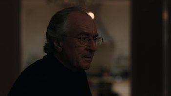 Movie still from “The Wizard of Lies” (2017), directed by Barry Levinson – An older man wearing glasses looking to his left; Close Up shot, Over the shoulder angle