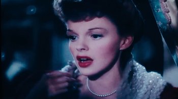 Movie still from “The Wizard of Lies” (2017), directed by Barry Levinson – A person wearing a necklace; Close Up shot, High angle