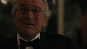 Movie still from “The Wizard of Lies” (2017), directed by Barry Levinson – An older man in a suit and bow tie; Close Up shot, Over the shoulder angle