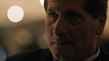 Movie still from “The Wizard of Lies” (2017), directed by Barry Levinson – A man's face in a dark room; Close Up shot, Over the shoulder angle