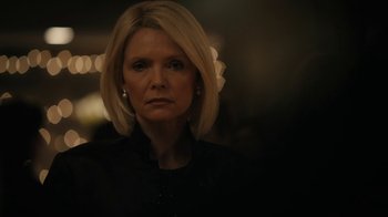 Movie still from “The Wizard of Lies” (2017), directed by Barry Levinson – A woman with blonde hair is looking at the camera; Close Up shot, Over the shoulder angle