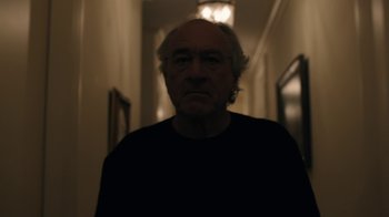 Movie still from “The Wizard of Lies” (2017), directed by Barry Levinson – An older man is standing in a dark room; Close Up shot, Low angle