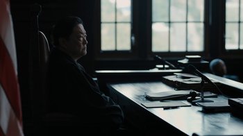 Movie still from “The Wizard of Lies” (2017), directed by Barry Levinson – An older man sitting at a table in front of a window; Medium shot, High angle