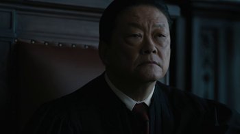 Movie still from “The Wizard of Lies” (2017), directed by Barry Levinson – An older man wearing a suit and tie; Close Up shot, Low angle