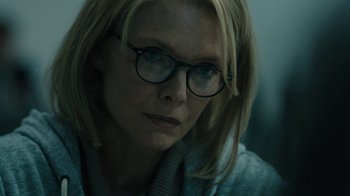 Movie still from “The Wizard of Lies” (2017), directed by Barry Levinson – A person wearing glasses; Close Up shot, Over the shoulder angle
