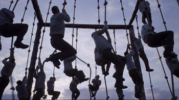 Movie still from “Full Metal Jacket” (1987), directed by Stanley Kubrick – A group of people hanging on ropes on a wooden structure; Wide shot, Low angle