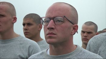 Movie still from “Full Metal Jacket” (1987), directed by Stanley Kubrick – A group of men standing next to each other wearing glasses; Close Up shot, Low angle