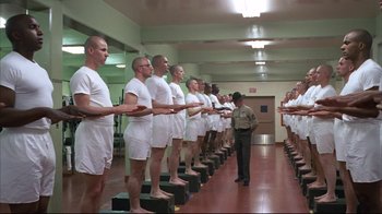 Movie still from “Full Metal Jacket” (1987), directed by Stanley Kubrick – A line of men in white shirts and white shorts; Wide shot, Low angle