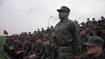 Movie still from “Full Metal Jacket” (1987), directed by Stanley Kubrick – A group of men in green fatigues and hats; Medium shot, Low angle