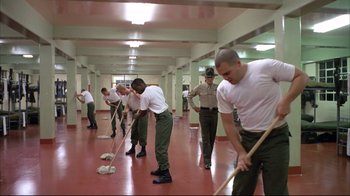 Movie still from “Full Metal Jacket” (1987), directed by Stanley Kubrick – A group of men cleaning a floor with mops; Wide shot, High angle